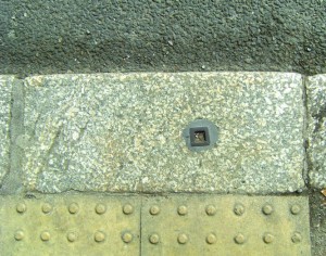 Kerbstone with metal pole socket