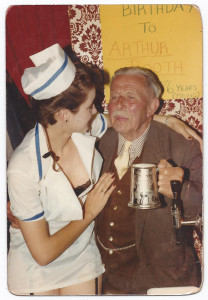 Arthur Booth's 76th birthday celebration in 1985, with a 'nurse' to see he doesn't go over the limit.