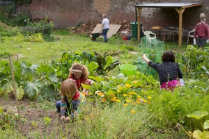 Walled Garden member Daniella and her children in a vegetable patch